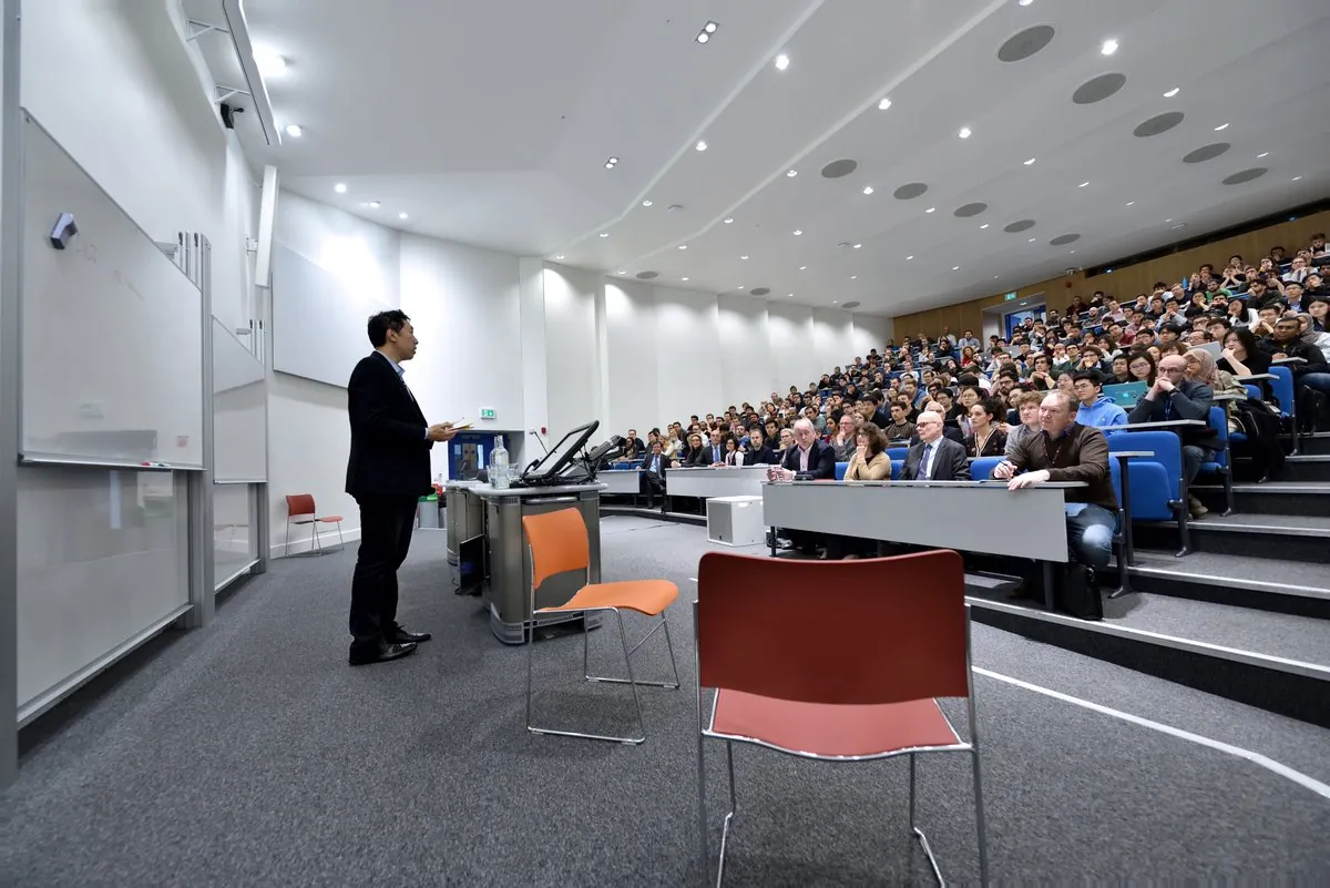 Andrew Ng speaking to a packed lecture theatre at Imperial College London